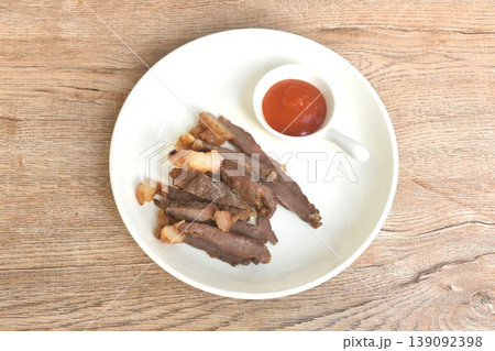 fried crispy salty fermenting beef fat meat with pepper on plate dipping spicy chili sauce fried crispy salty fermenting beef fat meat with pepper on plate dipping spicy chili sauce 139092398