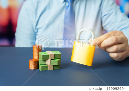 Financial risks insurance concept. Guarantee and saving of cash investments. Insurance Market Services. Financial stability. Business and Finance. Businessman holding lock near money. Financial risks insurance concept. Guarantee and saving of cash investments. Insurance Market Services. Financial stability. Business and Finance. Businessman holding lock near money. 139092494