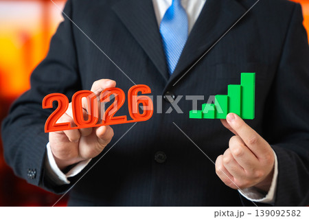 2026 year business growth. businessman holding rising graph showing success, revenue increase 2026 year business growth. businessman holding rising graph showing success, revenue increase 139092582