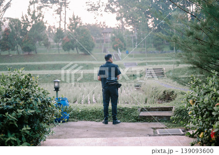 Rear view of man enjoying scenic rice field landscape Rear view of man enjoying scenic rice field landscape 139093600