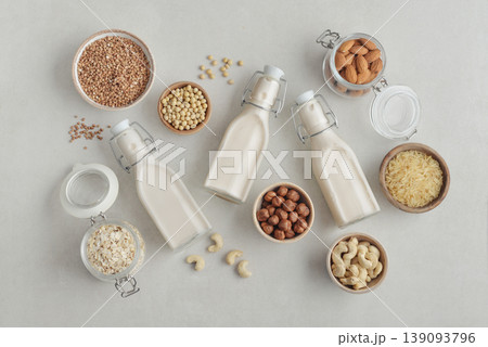 bottles with vegan milk on concrete a kitchen table bottles with vegan milk on concrete a kitchen table 139093796