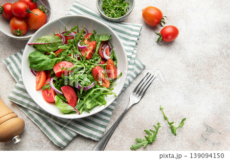 Fresh green salad with tomatoes and arugula Fresh green salad with tomatoes and arugula 139094150