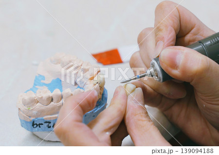 Crafting custom dentures with precision in a dental lab workspace Crafting custom dentures with precision in a dental lab workspace 139094188