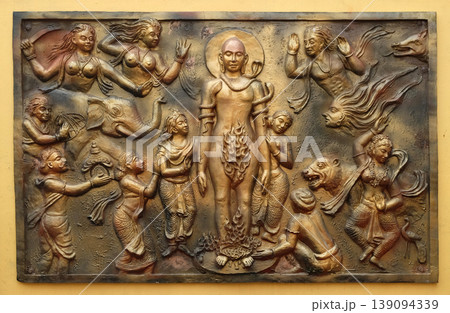 Jealous god Sangama tests Mahaviras enderance and, courage by twenty severe tests: Mahavira is victorius, Street bas relief on the wall of Jain Temple (also called Parshwanath Temple) in Kolkata, West Jealous god Sangama tests Mahaviras enderance and, courage by twenty severe tests: Mahavira is victorius, Street bas relief on the wall of Jain Temple (also called Parshwanath Temple) in Kolkata, West 139094339