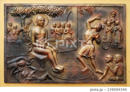 Who digs a ditch falls in it. Gosalaka hurls Tejolesya - fiery flame to burn Mahavira but he himself is burnt, Street bass relief on the wall of Jain Temple (also called Parshwanath Temple) in Who digs a ditch falls in it. Gosalaka hurls Tejolesya - fiery flame to burn Mahavira but he himself is burnt, Street bass relief on the wall of Jain Temple (also called Parshwanath Temple) in 139094340