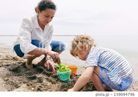 Mother And Toddler Playing Together On Beach With Sand Toys 139094796