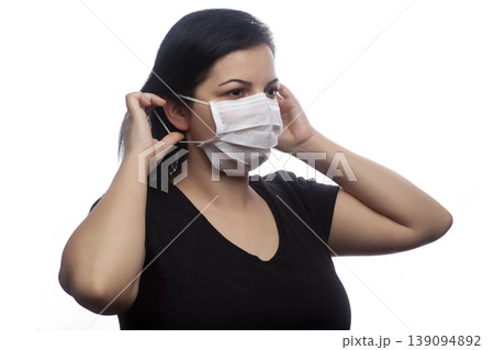 Woman wearing a white mask. 139094892