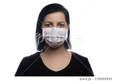 Woman wearing a white mask. 139094893