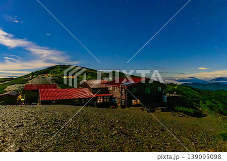 北アルプス 蝶ヶ岳ヒュッテの夜景 月光に照らされる山小屋とテント場の灯り 139095098