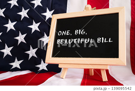 One Big Beautiful Bill Act chalkboard sign with American flag background, USA legislation budget concept 139095542