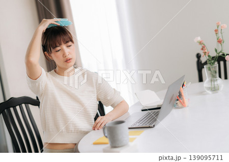 Stressed asian woman feeling sick with headache cooling forehead at home while working on online business and studying using modern computer technology Stressed asian woman feeling sick with headache cooling forehead at home while working on online business and studying using modern computer technology 139095711
