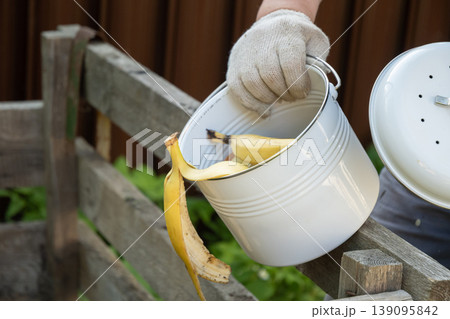 Composting organic kitchen waste with banana peels in garden eco lifestyle concept 139095842