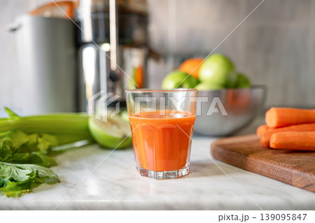 Fresh carrot juice close up with celery and apple natural vitamin drink 139095847