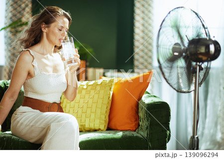 Refreshing Moment: Woman Drinks Iced Water Indoors Refreshing Moment: Woman Drinks Iced Water Indoors 139096294