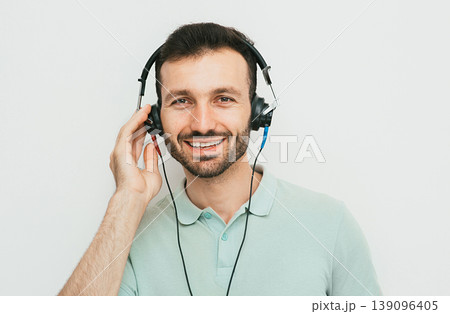 Hearing test, hearing diagnostic. A man wearing headphones having an audiometry test isolated in white 139096405
