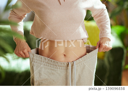 Slim Woman Demonstrating Weight Loss Progress Slim Woman Demonstrating Weight Loss Progress 139096838