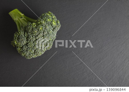 Organic Broccoli on Gray Granite Table. Green Broccoli on Dark Stone Surface Minimal Style. Organic Broccoli on Gray Granite Table. Green Broccoli on Dark Stone Surface Minimal Style. 139096844