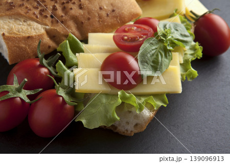 Fresh Sandwich with Cheese Tomato and Lettuce on Stone Background. Fresh Sandwich with Cheese Tomato and Lettuce on Stone Background. 139096913