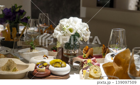 Luxury restaurant charcuterie board with artisan cheeses, cured meats, dates and edible flowers served at elegant Mediterranean dinner 139097509