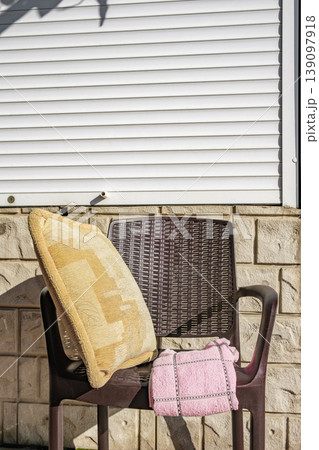 towel and pillow on a plastic chair towel and pillow on a plastic chair 139097918
