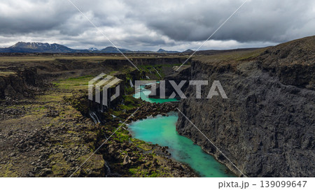 Dramatic Icelandic Canyon with Turquoise River and Waterfalls 139099647