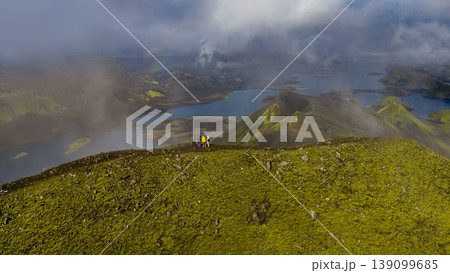 Aerial View of Hikers on Moss Covered Ridge in Iceland's Volcanic Landscape Aerial View of Hikers on Moss Covered Ridge in Iceland's Volcanic Landscape 139099685
