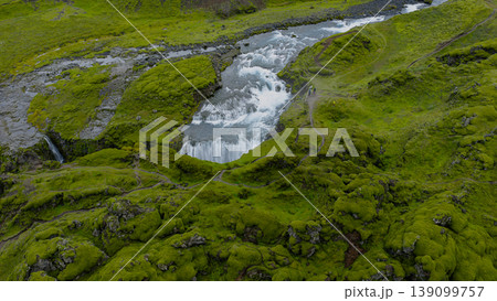 Aerial View of a Small Waterfall Amid Moss Covered Terrain in Iceland Aerial View of a Small Waterfall Amid Moss Covered Terrain in Iceland 139099757