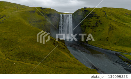 Aerial View of Skogafoss Waterfall and Surrounding Green Hills in Iceland 139099828