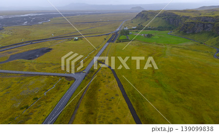 Aerial View of Icelandic Fields, Roads, Cliffs, and River 139099838