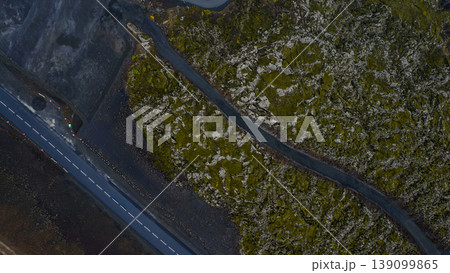 Aerial View of Winding Road Through Moss Covered Volcanic Terrain in Iceland 139099865