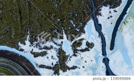 Aerial View of Iceland's Snowy Terrain and Volcanic Rock Formations Aerial View of Iceland's Snowy Terrain and Volcanic Rock Formations 139099866