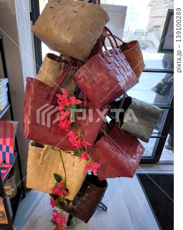 A collection of modern woven leather or polymer accessories in the interior of a fashion boutique A collection of modern woven leather or polymer accessories in the interior of a fashion boutique 139100289