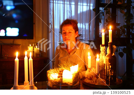 Woman Relaxing at Home with Candles Hygge Lifestyle Woman Relaxing at Home with Candles Hygge Lifestyle 139100525