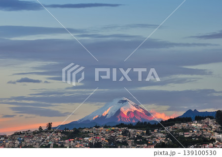 Cotopaxi volcano towering over quito city at sunset Cotopaxi volcano towering over quito city at sunset 139100530
