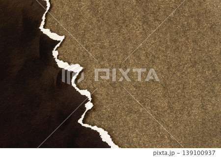 Torn paper edge revealing dark layer on cardboard background with rough surface, strong copy space for design, layout, branding, template use, texture detail composition. Natural background 139100937