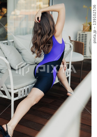 Terrace Relaxation White Woman Stretching On Sofa In Unitard And Heels, Casual Pose With Extended Leg And Soft Cushion Seating, Warm Morning Light And Understated Editorial Vibe. Terrace Relaxation White Woman Stretching On Sofa In Unitard And Heels, Casual Pose With Extended Leg And Soft Cushion Seating, Warm Morning Light And Understated Editorial Vibe. 139102536