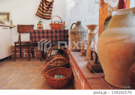 Closeup Pottery And Woven Baskets Arranged On Checkered Cloth With Terracotta Jars And Wicker Handles, Sunlit Textures, Braided Details And Vintage Homely Accents Ideal For Craft Market Closeup Pottery And Woven Baskets Arranged On Checkered Cloth With Terracotta Jars And Wicker Handles, Sunlit Textures, Braided Details And Vintage Homely Accents Ideal For Craft Market 139102570