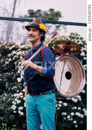 Cheerful Latin American man posing with a bass drum on his back, Chilean chinchinero, street musician who plays the bass drum and cymbals and dances in the streets, Chilean cultural tradition Cheerful Latin American man posing with a bass drum on his back, Chilean chinchinero, street musician who plays the bass drum and cymbals and dances in the streets, Chilean cultural tradition 139104785