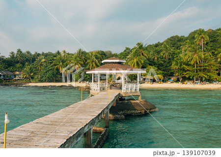 Wooden pier with pavilion on a tropical beach at sunset 139107039