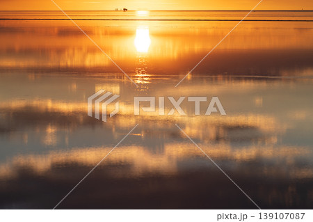 Serene golden sunset reflection at Salar de Uyuni in Bolivia 139107087