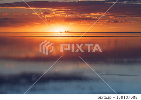 Serene sunset reflection over Salar de Uyuni salt flat in Bolivia Serene sunset reflection over Salar de Uyuni salt flat in Bolivia 139107088