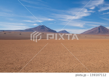 Surreal arid landscape of salvador dali desert with mountain view Surreal arid landscape of salvador dali desert with mountain view 139107112