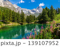 Lago Blu surrounded by green trees as Matterhorn peak under blue sky on background. in the Aosta Valley, Italy. 139107952