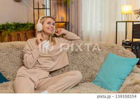 Adult woman listening to music in wireless headphones, moving slowly calm relaxed peaceful rhythm 139108354