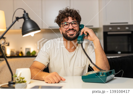 Arabian man hotline support operator uses retro corded phone listens asks questions finds solution Arabian man hotline support operator uses retro corded phone listens asks questions finds solution 139108417
