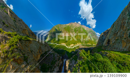 Panoramic view of vast mountain landscape with waterfall 139109900