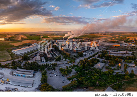 Industrial cement plant with smokestacks and fields at sunset, wide angle view from above 139109995