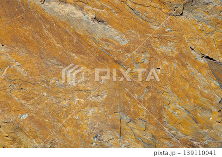 Close-up of textured rock face with grey and blue veins Close-up of textured rock face with grey and blue veins 139110041