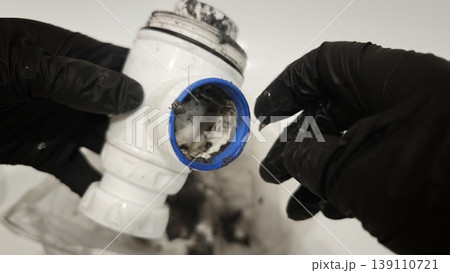 Cleaning a sink trap to remove dirt and clogs in a bathroom Cleaning a sink trap to remove dirt and clogs in a bathroom 139110721