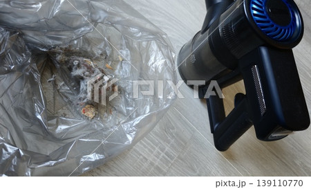 Dust and debris collection during cleaning with vacuum cleaner on floor Dust and debris collection during cleaning with vacuum cleaner on floor 139110770